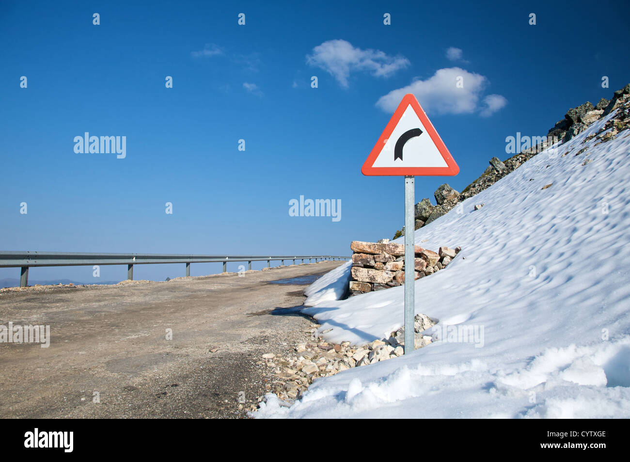 danger curve sign and snow in salamanca spain Stock Photo Alamy