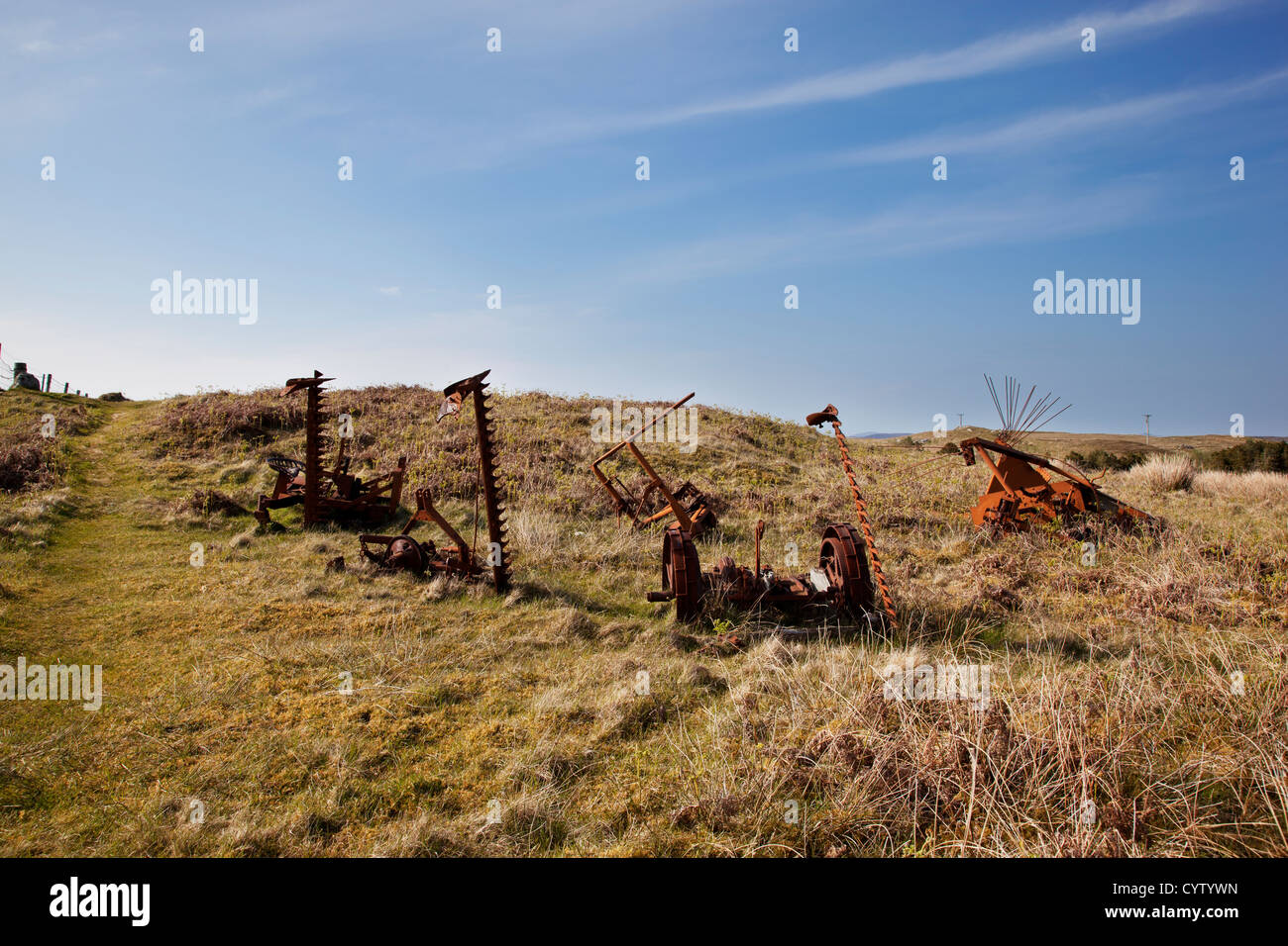 Abandoned rusty old farm machinery at Flodaigh on Benbecular, Outer Hebrides, Scotland, UK Stock Photo