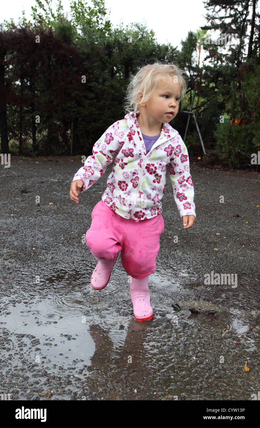 Toddler girl with rubber boots Stock Photo - Alamy