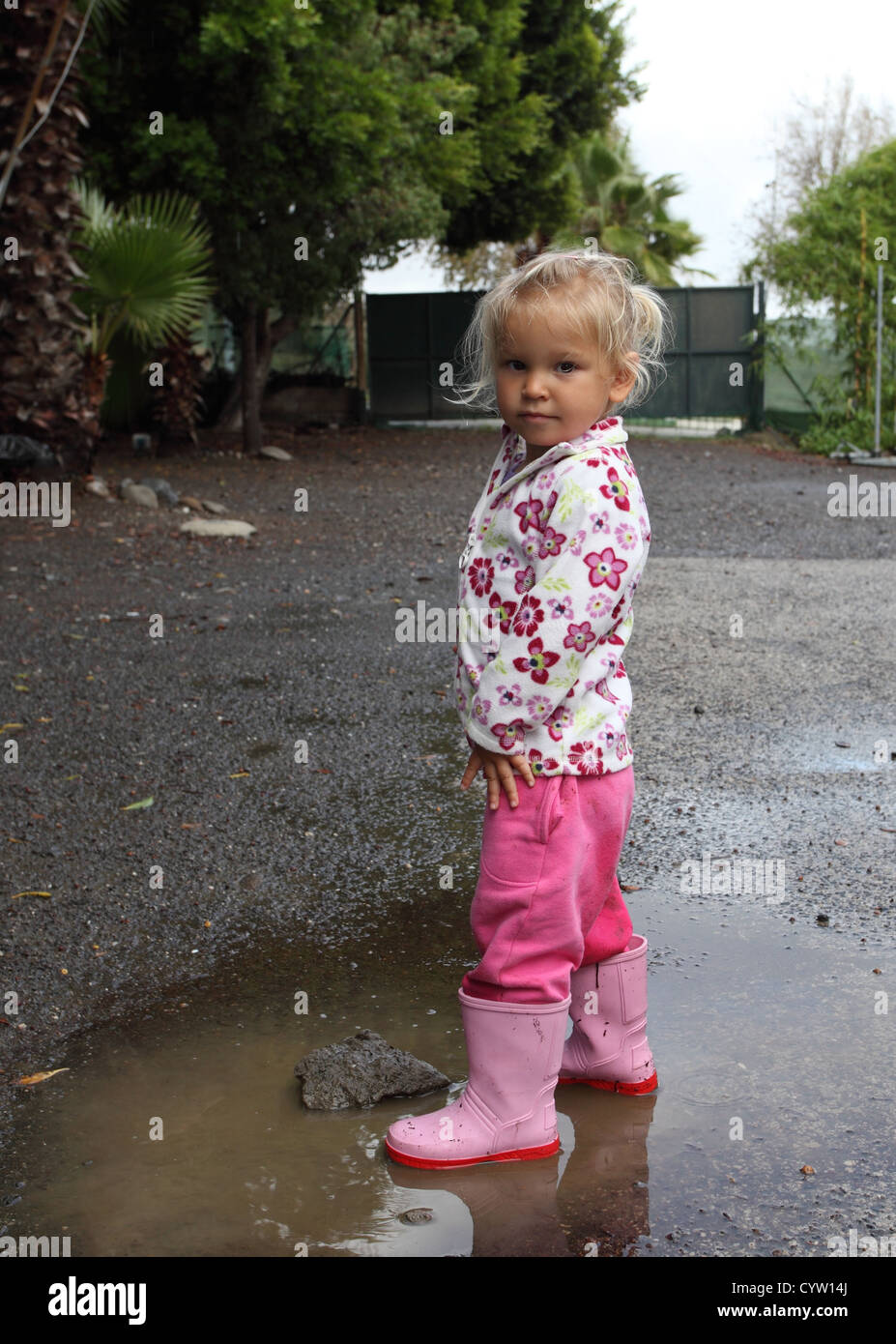 Toddler girl with rubber boots Stock Photo - Alamy
