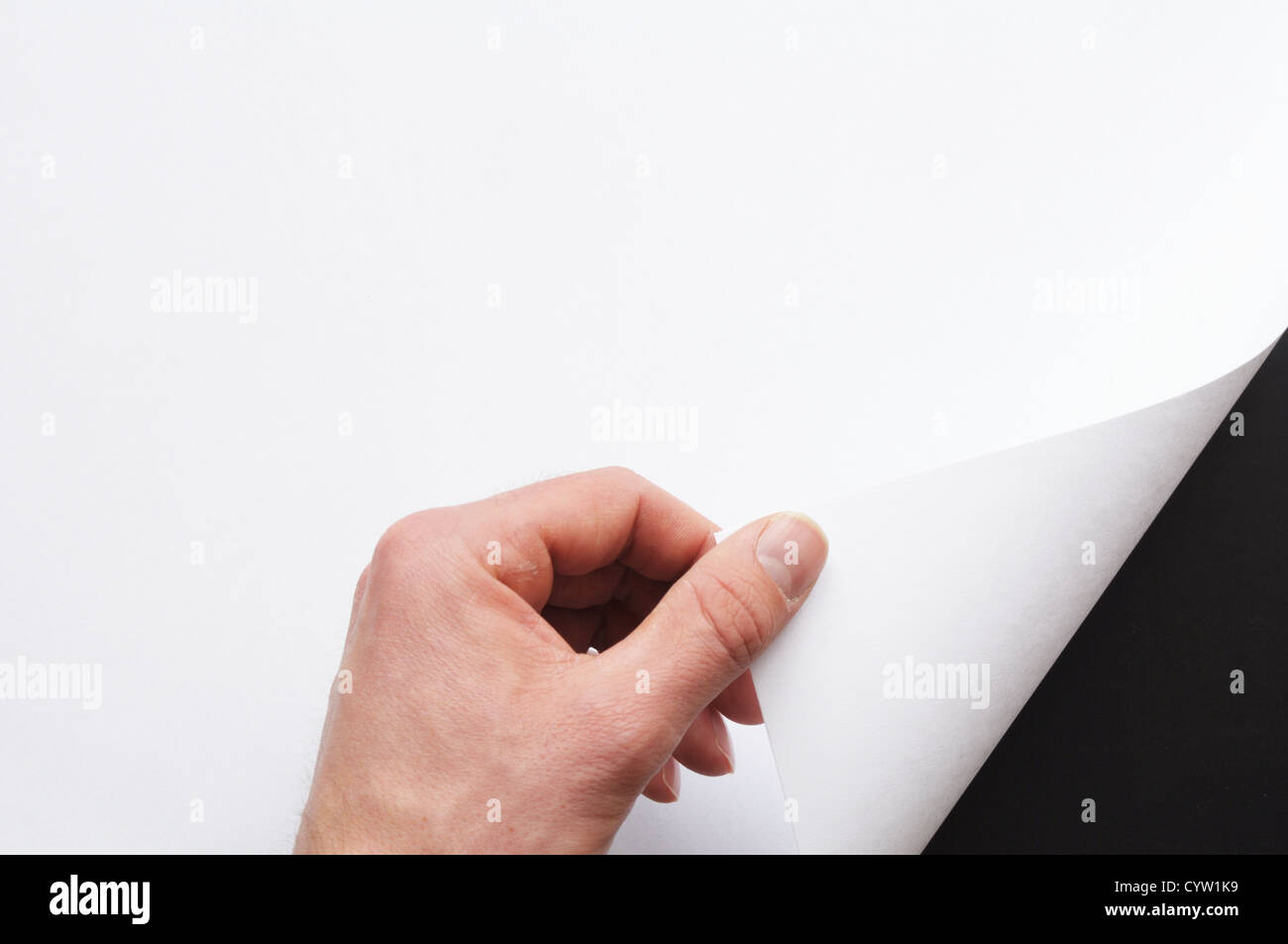 hand turning over blank sheet of paper Stock Photo