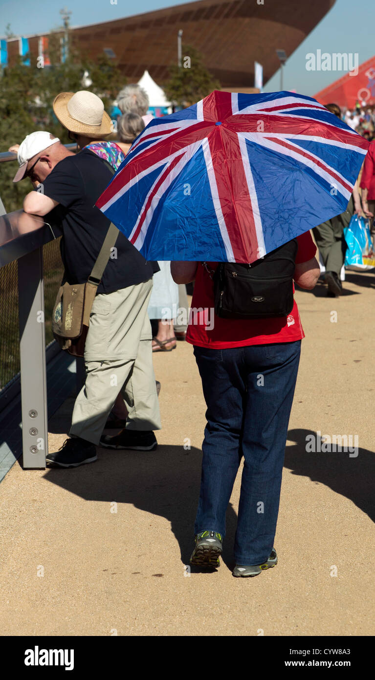 Close-up of a visitor to the Olympic Park using a Union Jack umbrella, as a sunshade, during the 2012 London Paralympic  Games Stock Photo