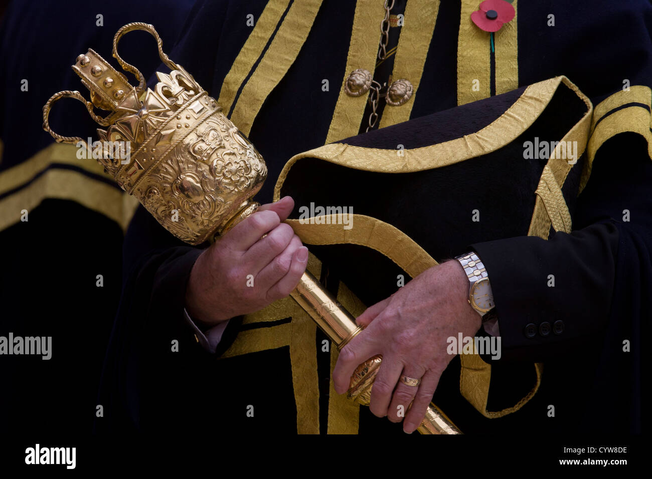 A Beadle macebearer from the City of London holds a ceremonial mace in