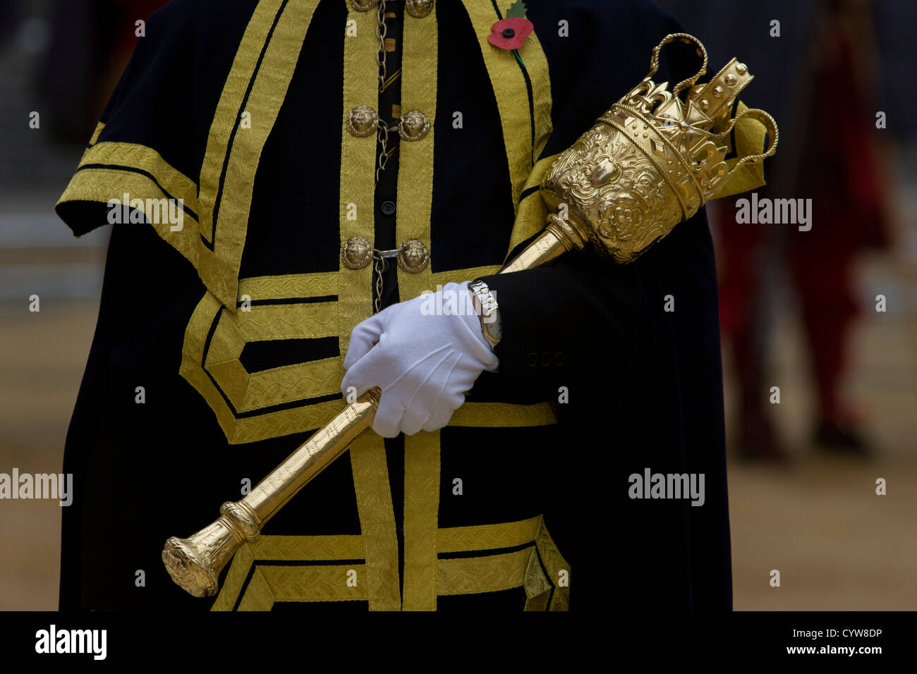 A Beadle macebearer from the City of London holds a ceremonial mace in