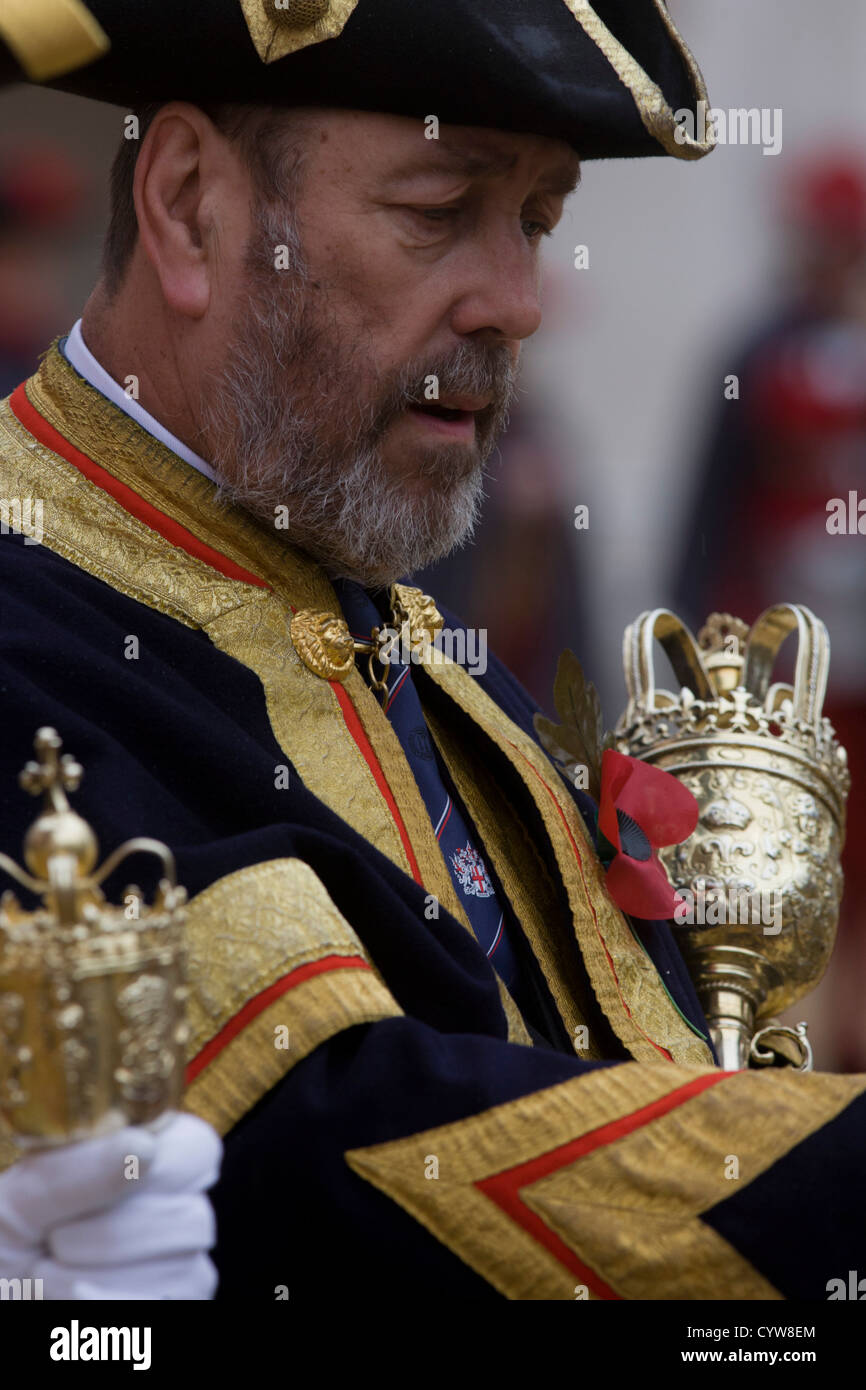 A Beadle macebearer from the City of London holds a ceremonial mace in