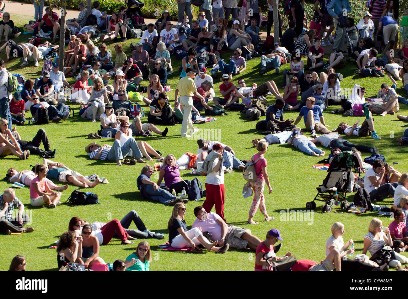 Visitors listening to music in the Bandstand area of the Olympic Park, Stratford. Stock Photo
