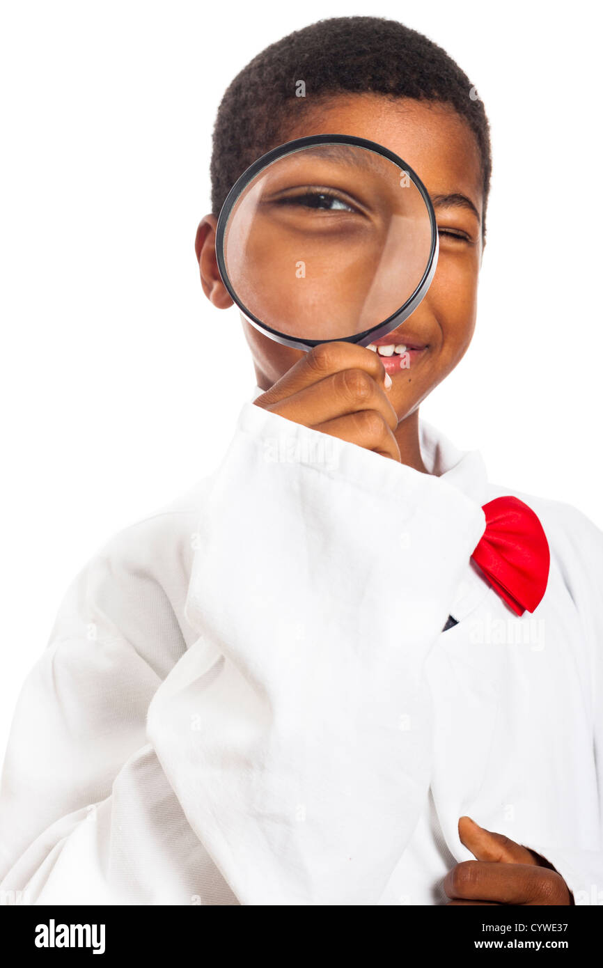 Happy clever scientist school boy with magnifying glass, isolated on white background. Stock Photo