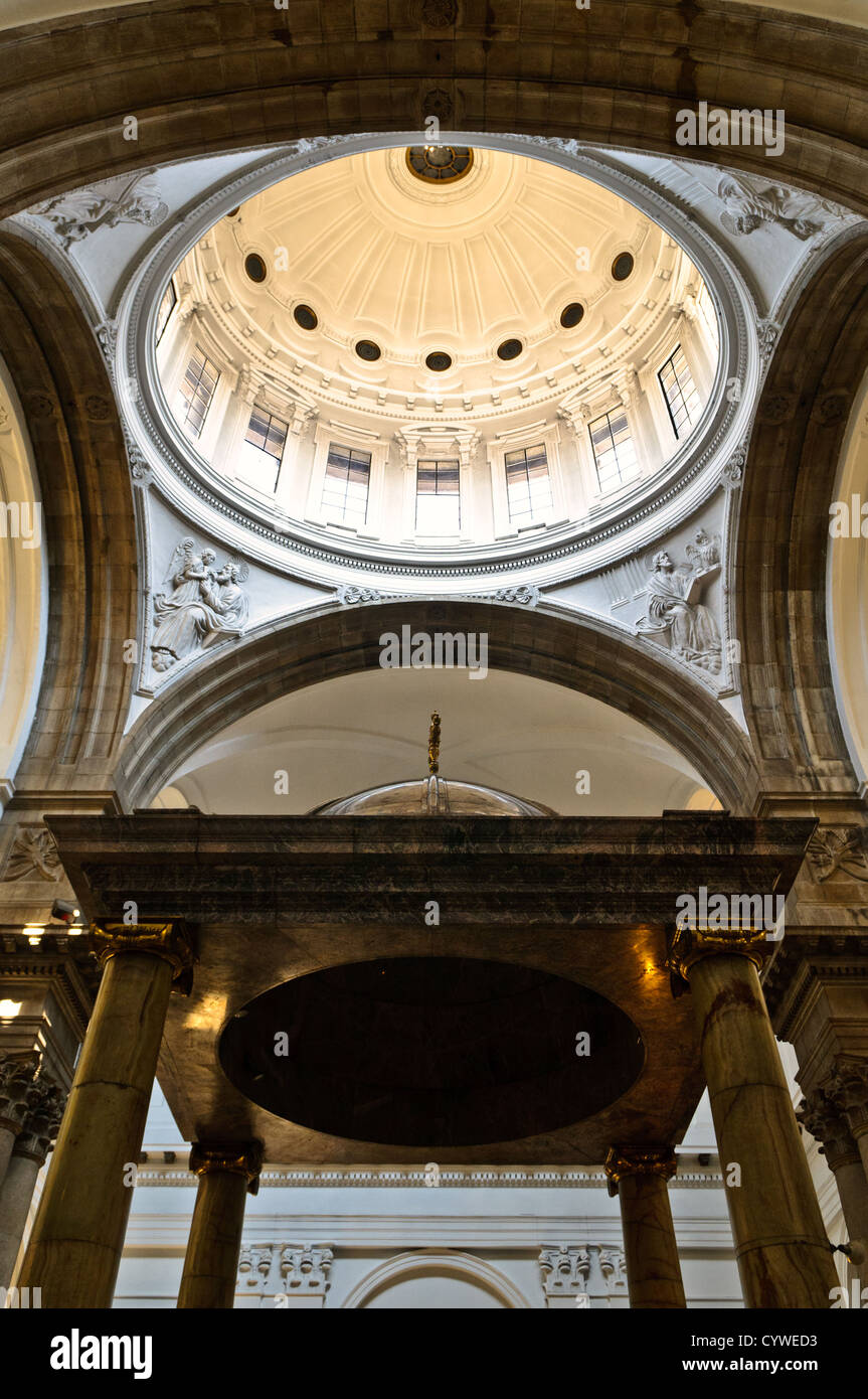 GUATEMALA CITY, Guatemala — The ornate interior of Catedral Metropolitana Santiago de Guatemala. Towering columns support vaulted ceilings adorned with intricate frescoes, while gilded altars and religious artwork line the nave, showcasing the cathedral's blend of neoclassical and baroque styles. Stock Photo