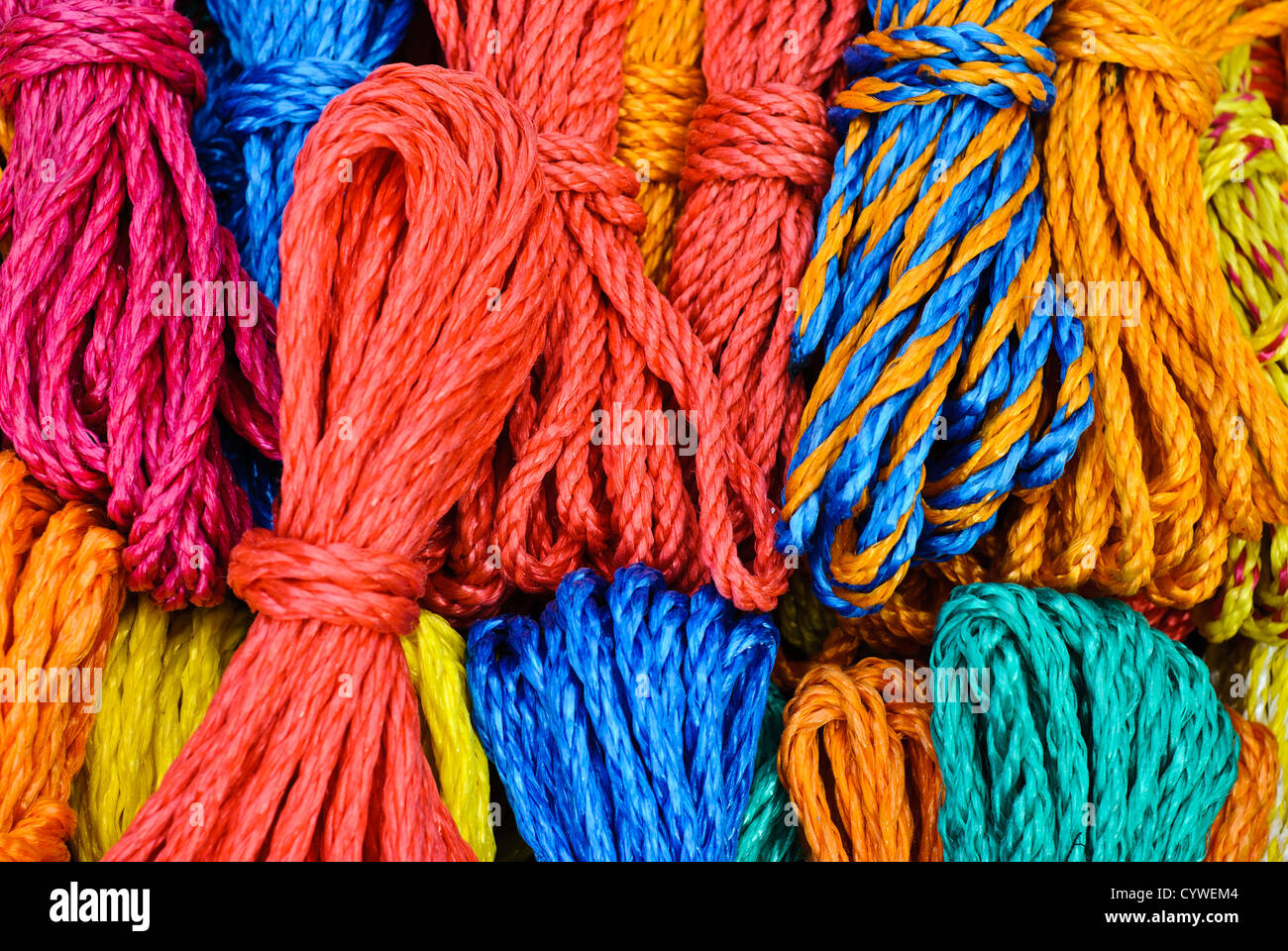 Brightly colored ropes for sale at a market in Antigua Guatemala. Famous for its well-preserved Spanish baroque architecture as well as a number of ruins from earthquakes, Antigua Guatemala is a UNESCO World Heritage Site and former capital of Guatemala. Stock Photo