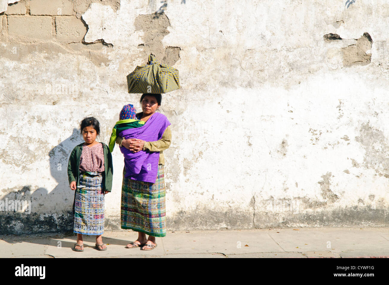 A Guatemalan woman poses with her daughter and baby on a street in Antigua, Guatemala. Stock Photo