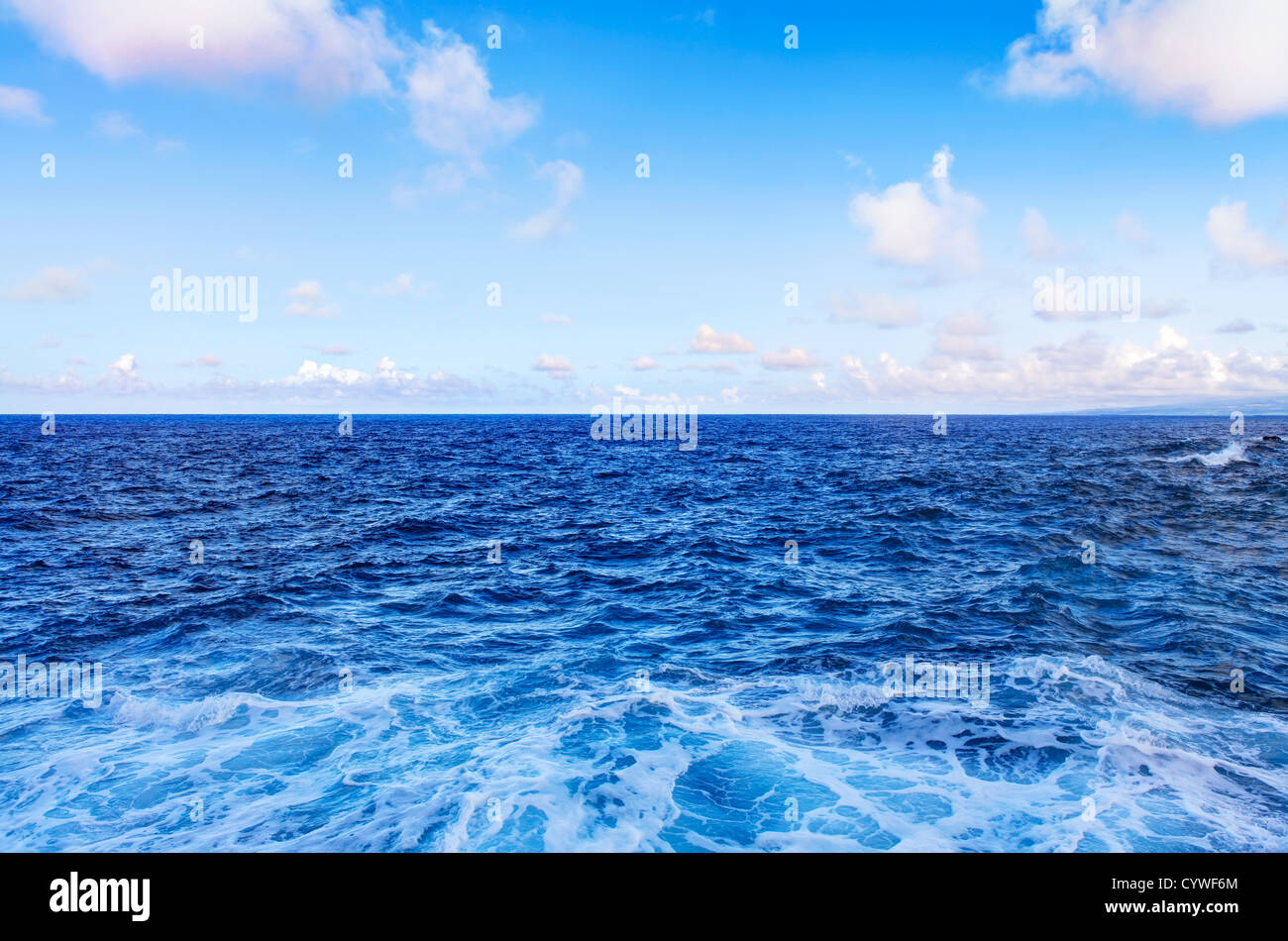 Ocean water waves and blue sky with white clouds Stock Photo - Alamy