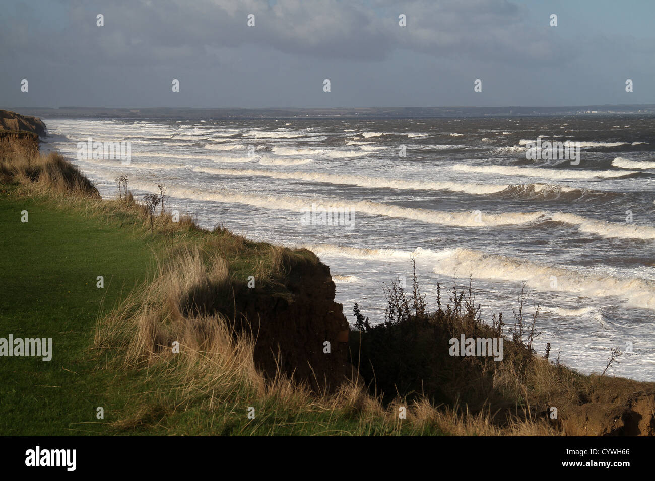 Rough sea and clay cliff erosion. Stock Photo