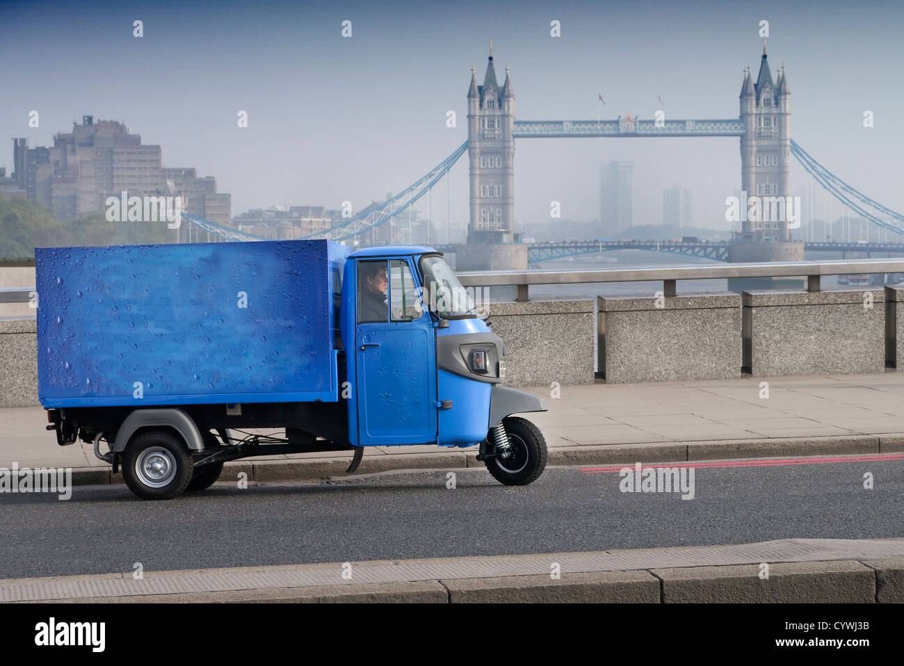 Piaggio scooter delivery van on London Bridge London UK Stock Photo