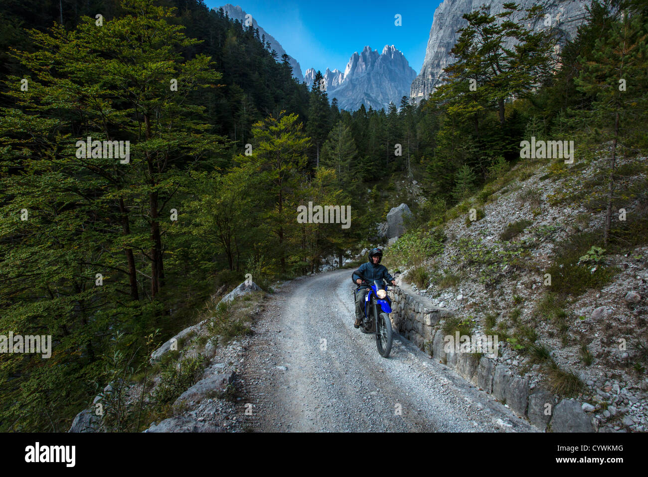 A motorbike drives in the Brenta Dolomites, Italy Stock Photo