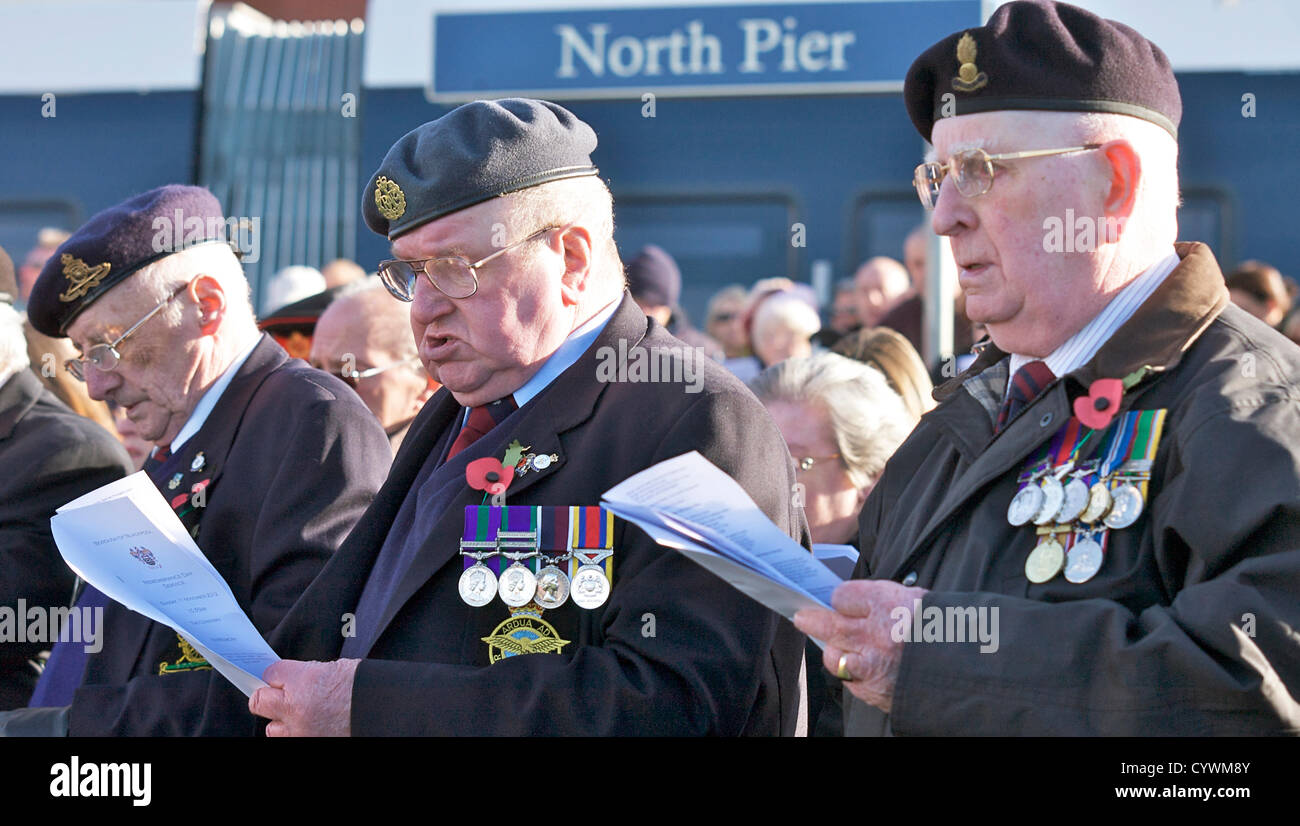 Blackpool,UK  11th November 2012.  Remembrance service held at Blackpool cenotaph on the seafront next to north pier. Three bespectacled ex servicemen tak part in the singing. Alamy Live News Stock Photo
