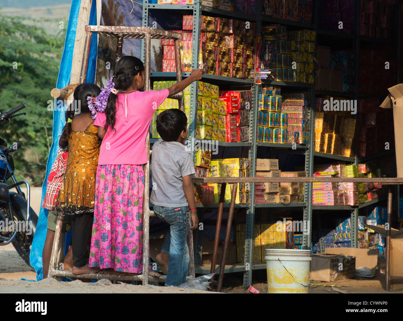 Indian children looking into a temporary Indian firework shop at Diwali. Puttaparthi, Andhra Pradesh, India Stock Photo