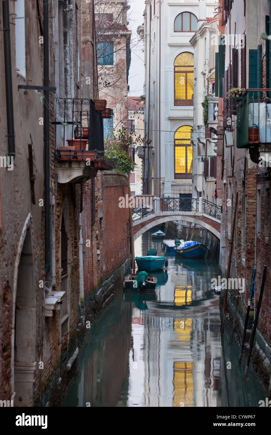 Bridge over a Venetian Canal. Reflections are on the water Stock Photo ...