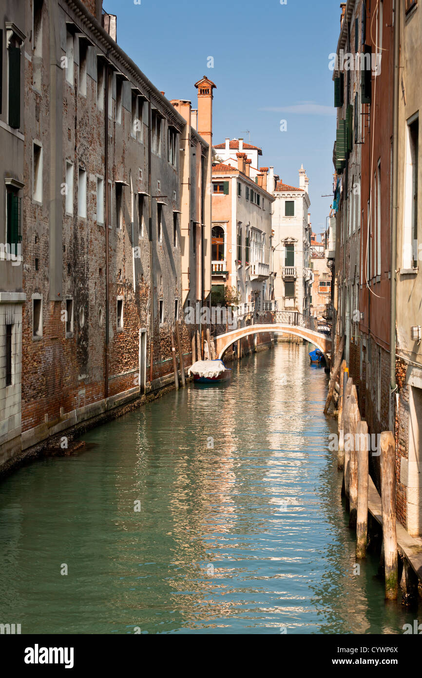 Bridge over a Venetian Canal. Reflections are on the water Stock Photo ...