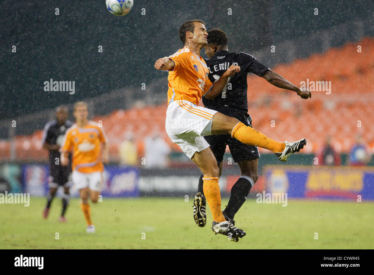 Patrick Ianni of the Houston Dynamo (L) and Luciano Emilio of DC United (R) contest a header during a Major League soccer match. Stock Photo