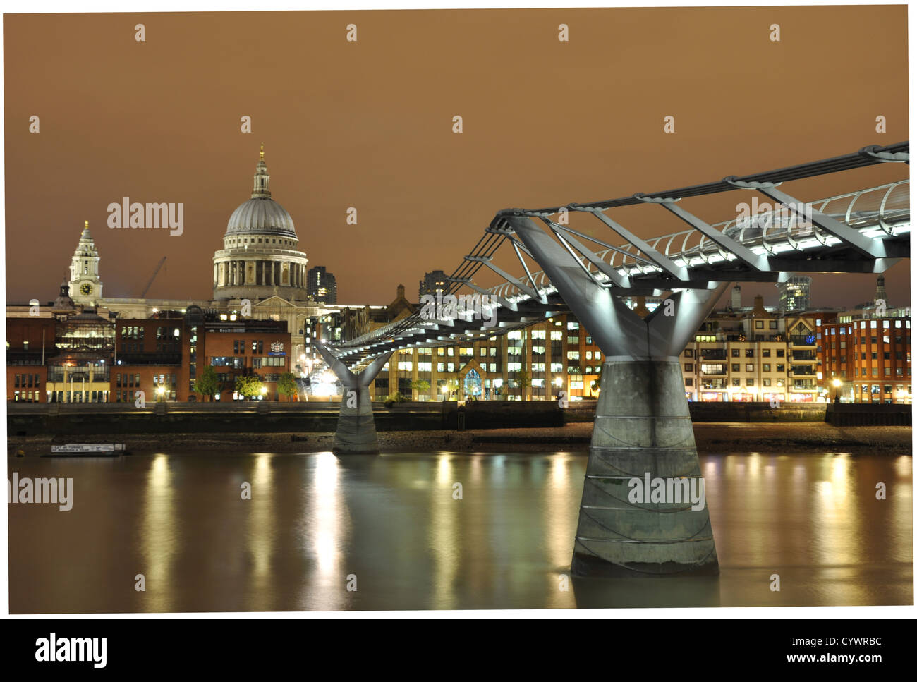 A night scene of St Paul's Cathedral and the Millennium Bridge crossing the River Thames in London Stock Photo