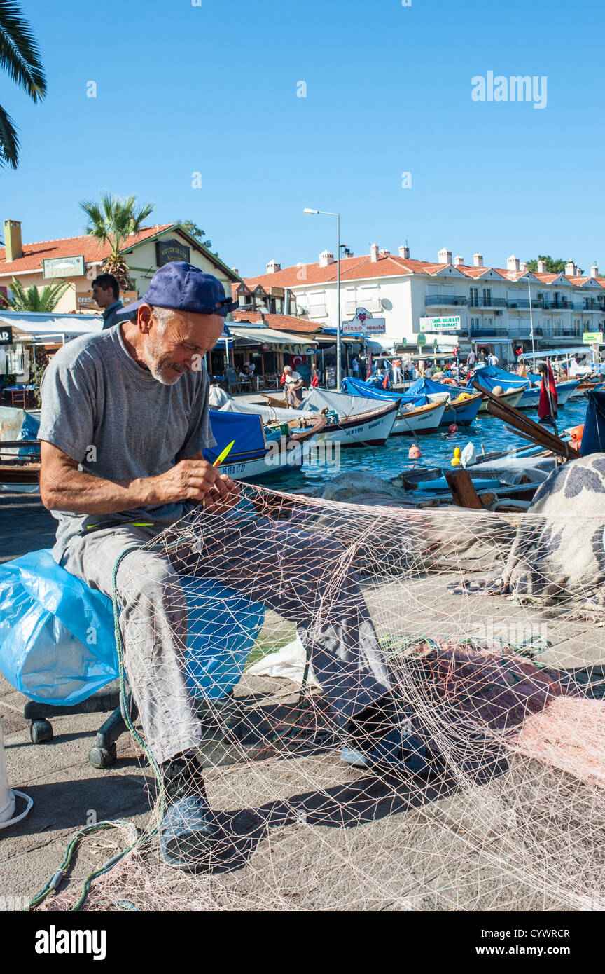 Mending fishing nets at the harbour edge in Foca Turkey Stock Photo Alamy