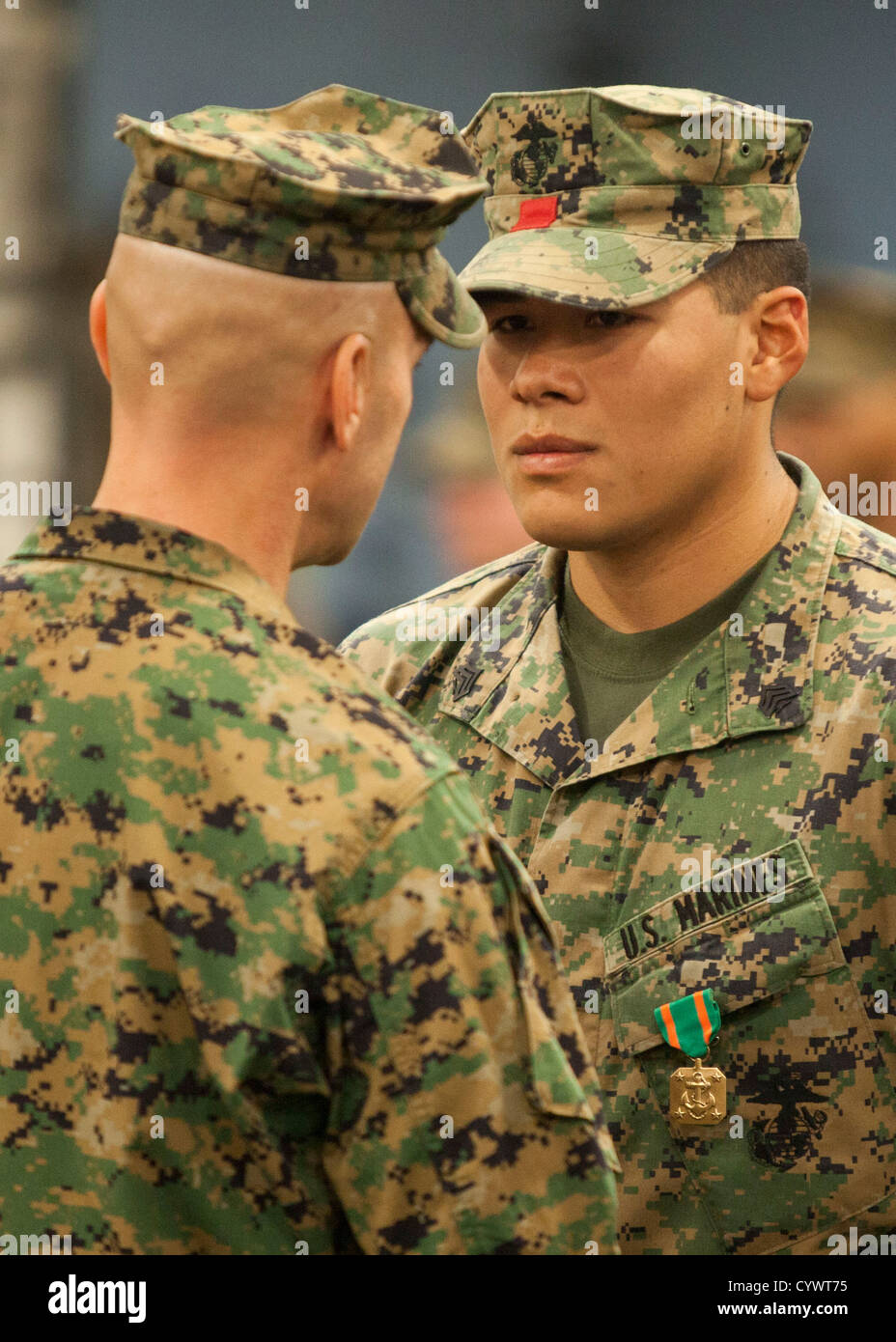 Sgt. Michael Espinoza, a landing support specialist, receives a Navy Achievement Medal from Col. Matthew St. Clair, 26th Marine Stock Photo