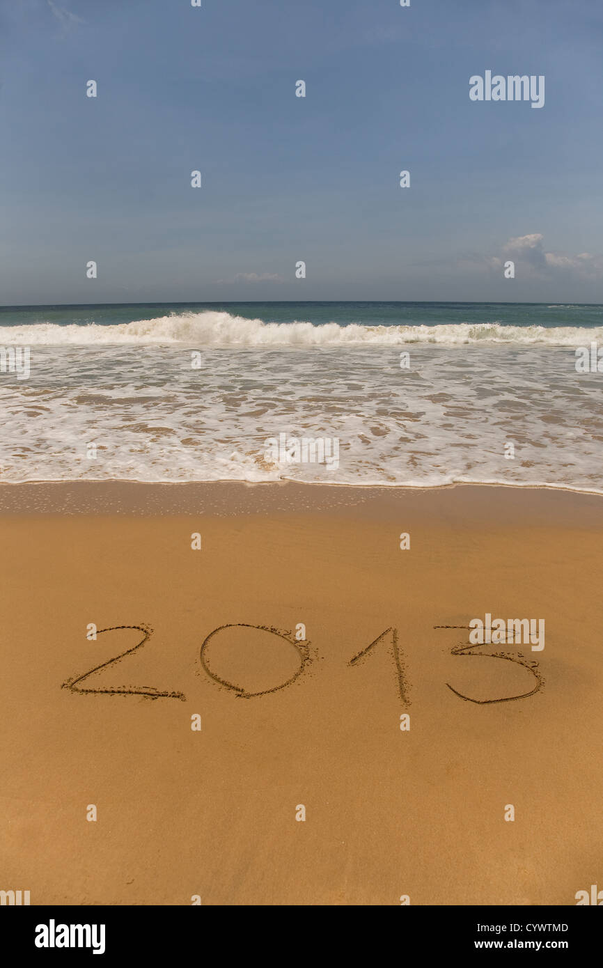 2013 written in sand on beach with sea waves Stock Photo