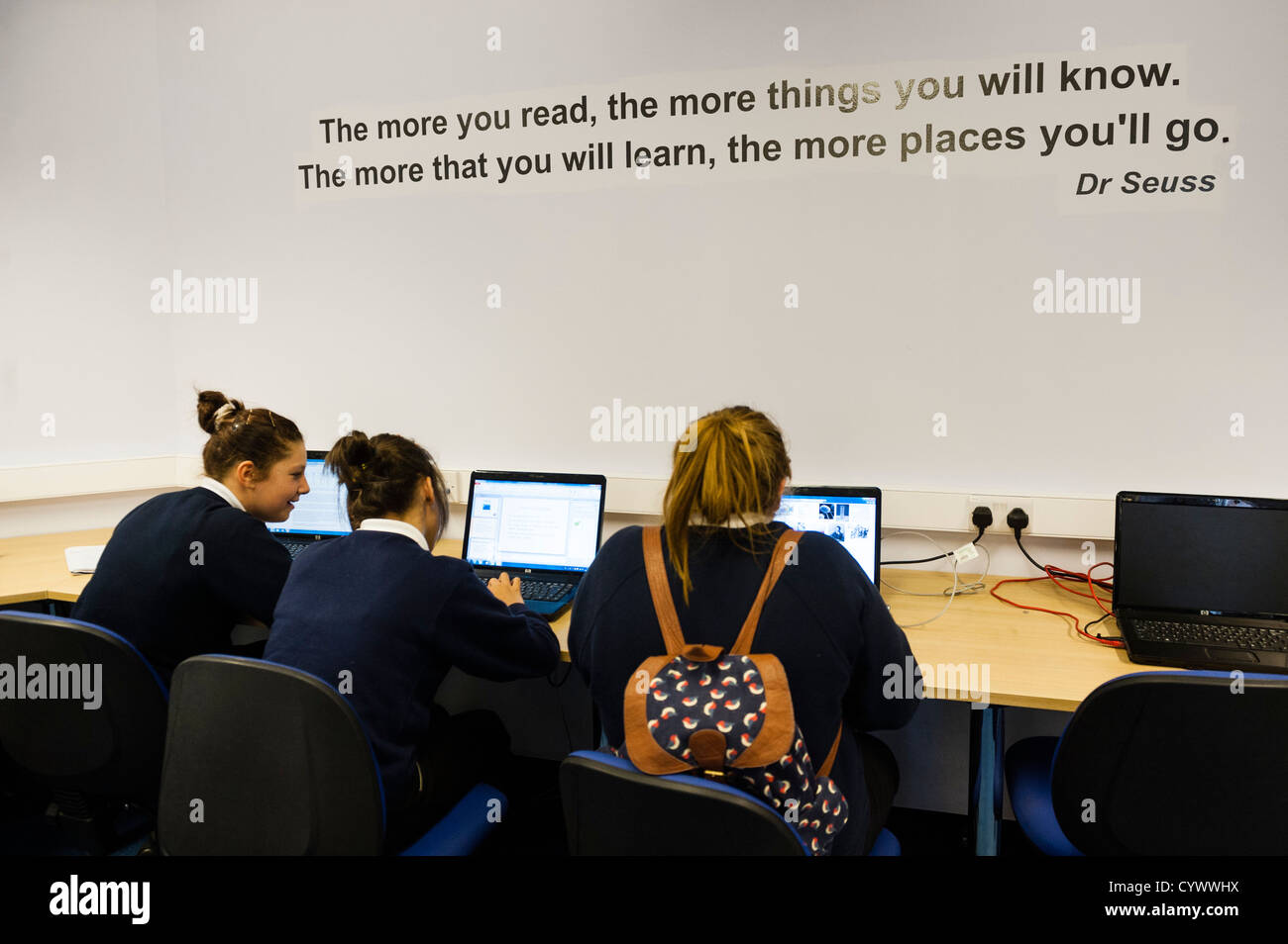 Three girls using computer digital technology ICT at a secondary school ...
