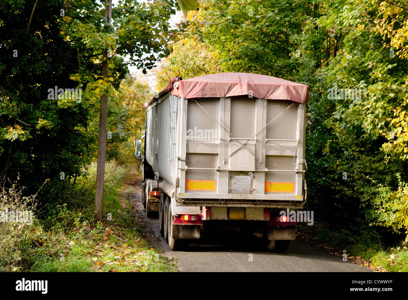 A large HGV lorry truck driving on a narrow country road, Suffolk UK