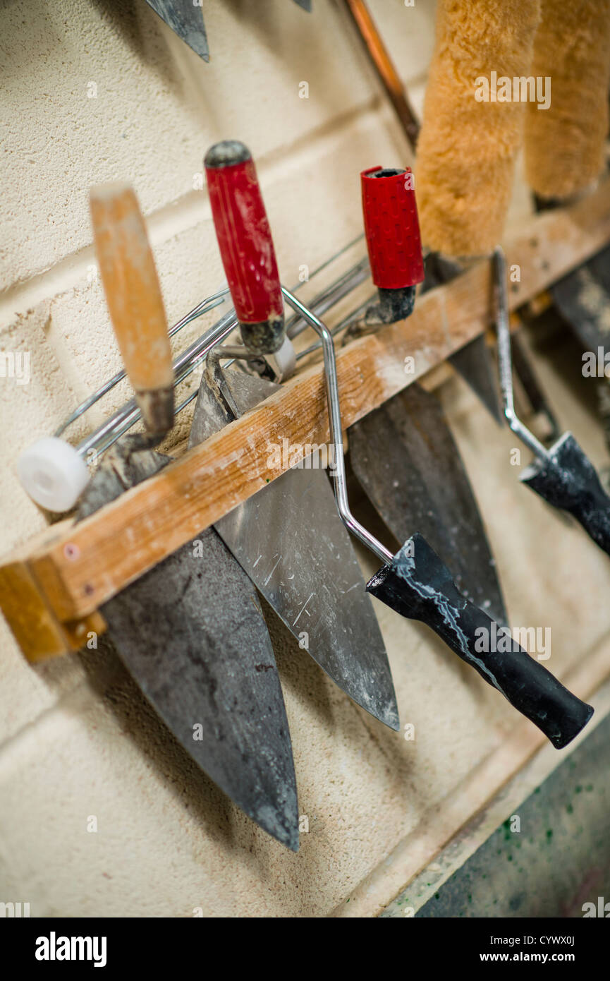 A rack of trowels in a Building technology vocational training workshop at a secondary comprehensive school, Wales UK Stock Photo