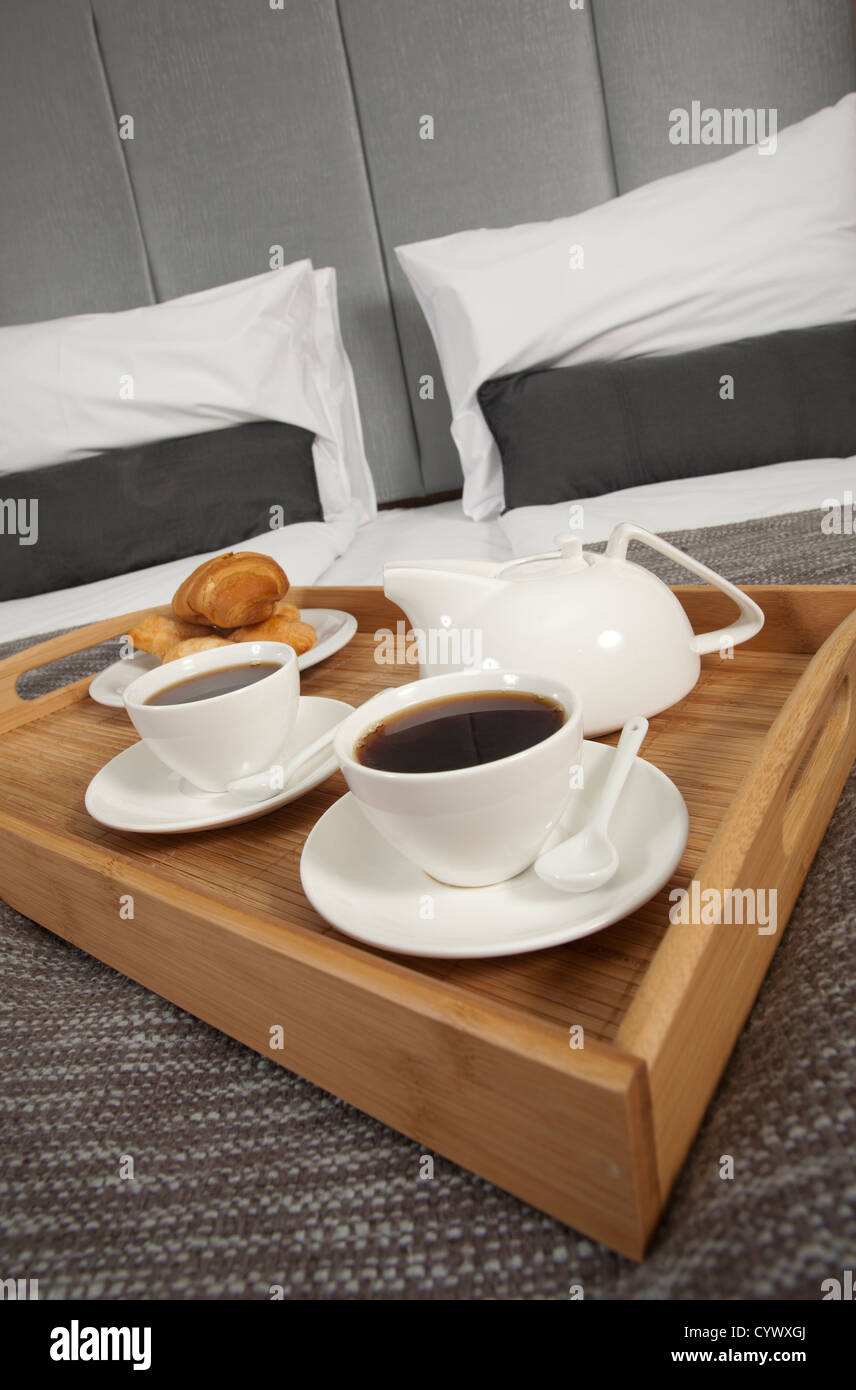 Tray with coffee on a bed in a hotel room Stock Photo Alamy