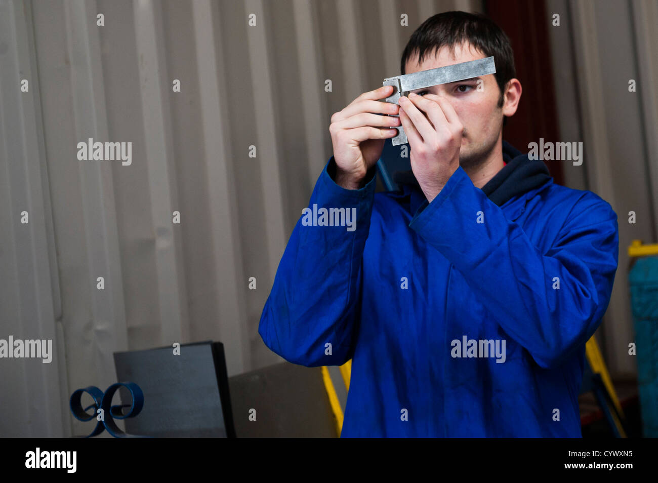 A teenage boy learning practical mechanical skills in a secondary comprehensive school workshop in Wales UK Stock Photo