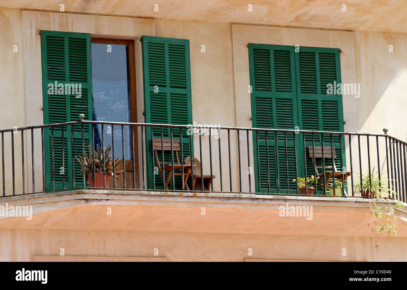 Balcony of traditional Spanish home with shutters in background. Stock Photo