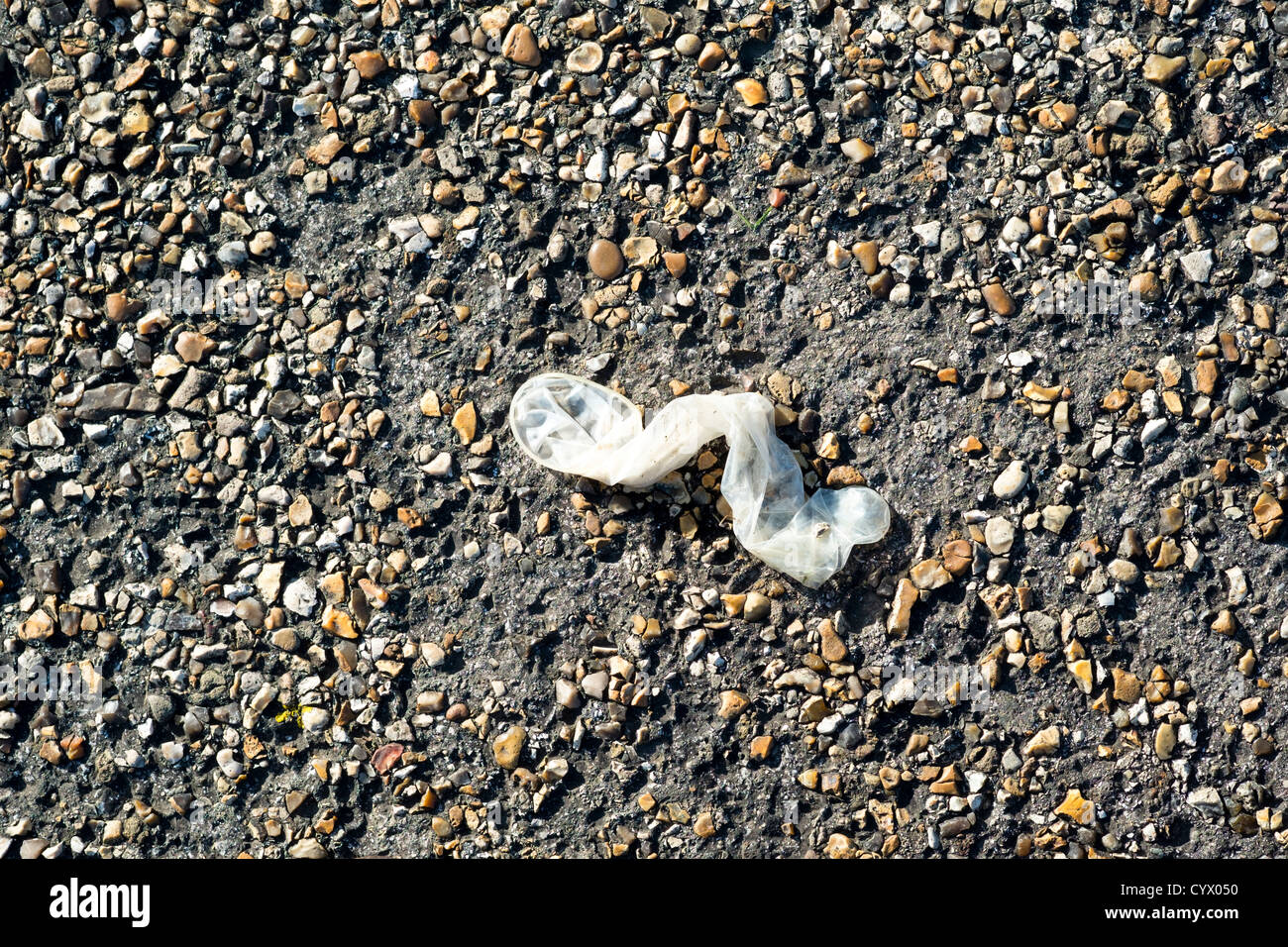 Discarded condom left on public path Stock Photo