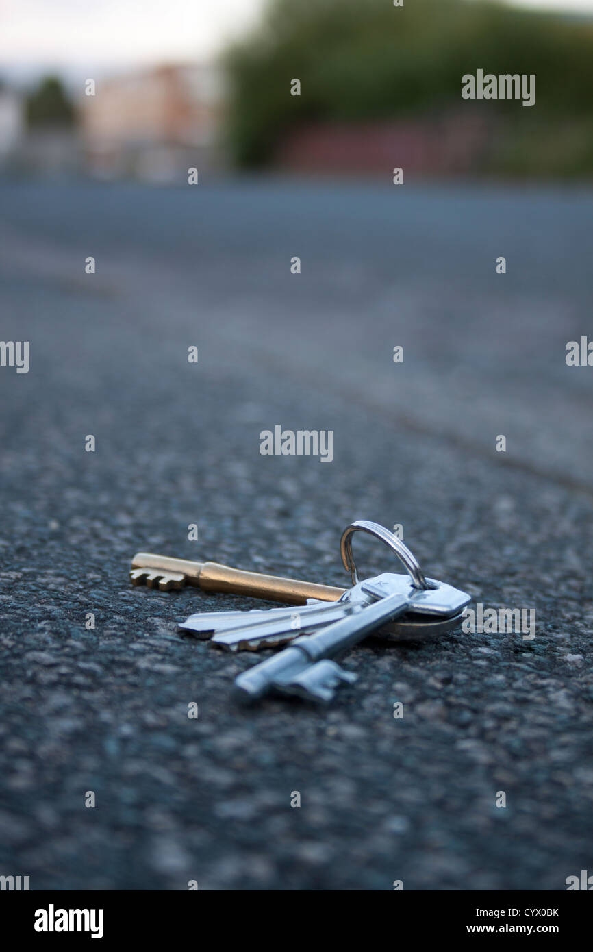 Keys lying on ground near some buildings Stock Photo
