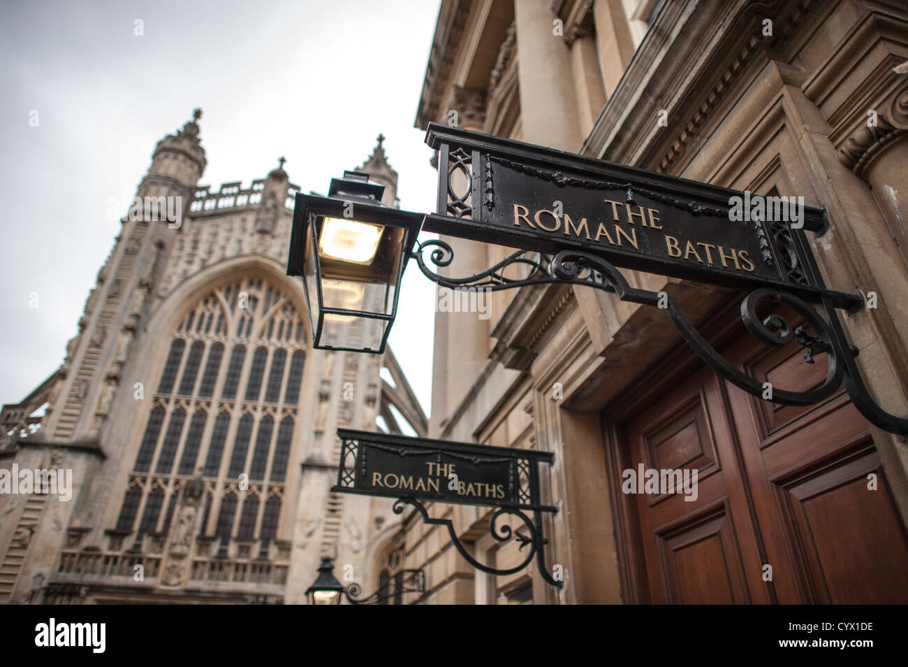 BATH, UK - The entrance to the historic Roman Baths that give the city of Bath, Somerset, its name. In the background, at left, is the tower of Bath Abbey. Stock Photo