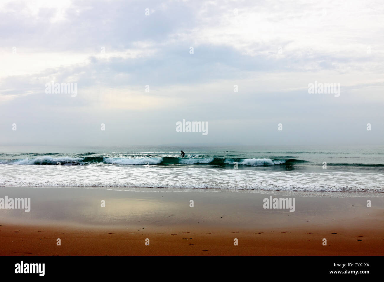 Lonely surfer in Bolonia Beach. Cadiz. Andalusia. Spain Stock Photo