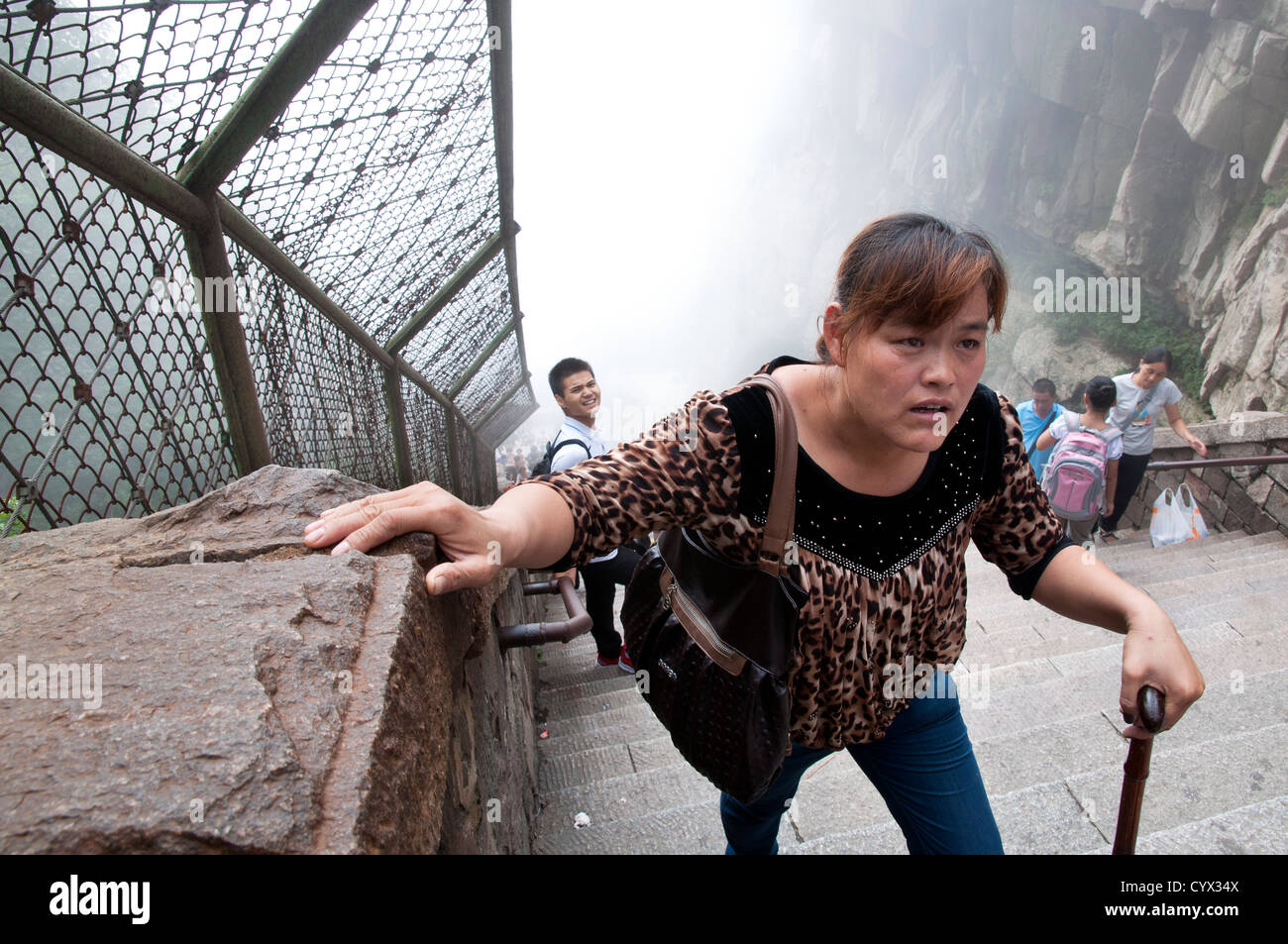 A tired-looking woman climbing the Stairway to Heaven, Taishan, China Stock Photo