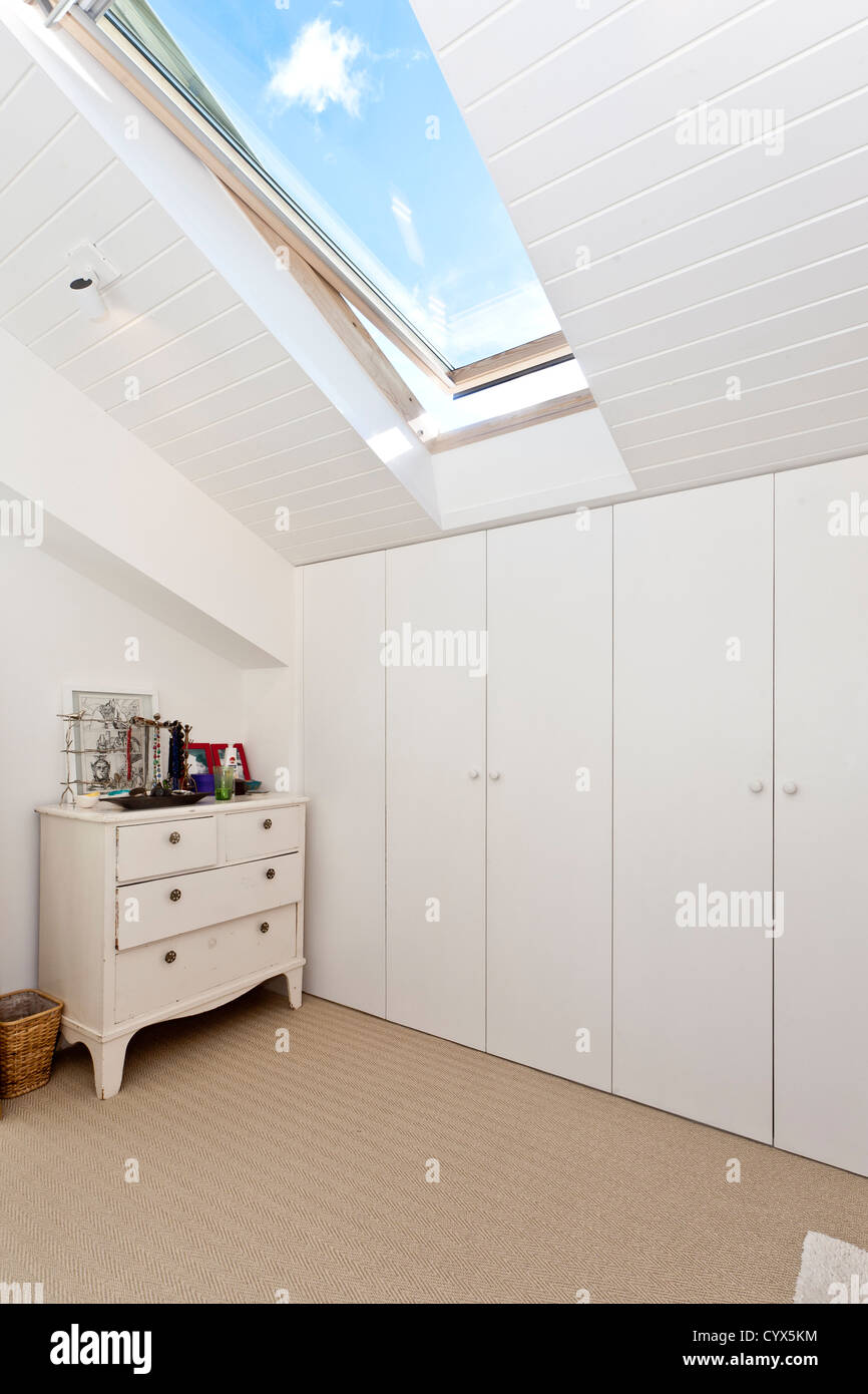 White bedroom cupboards and skylight Stock Photo