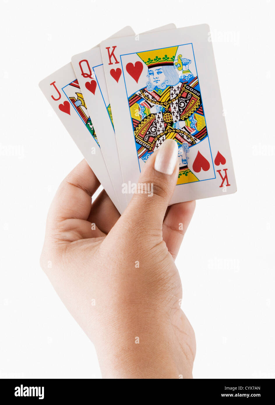 Close-up of a woman's hand holding playing cards Stock Photo