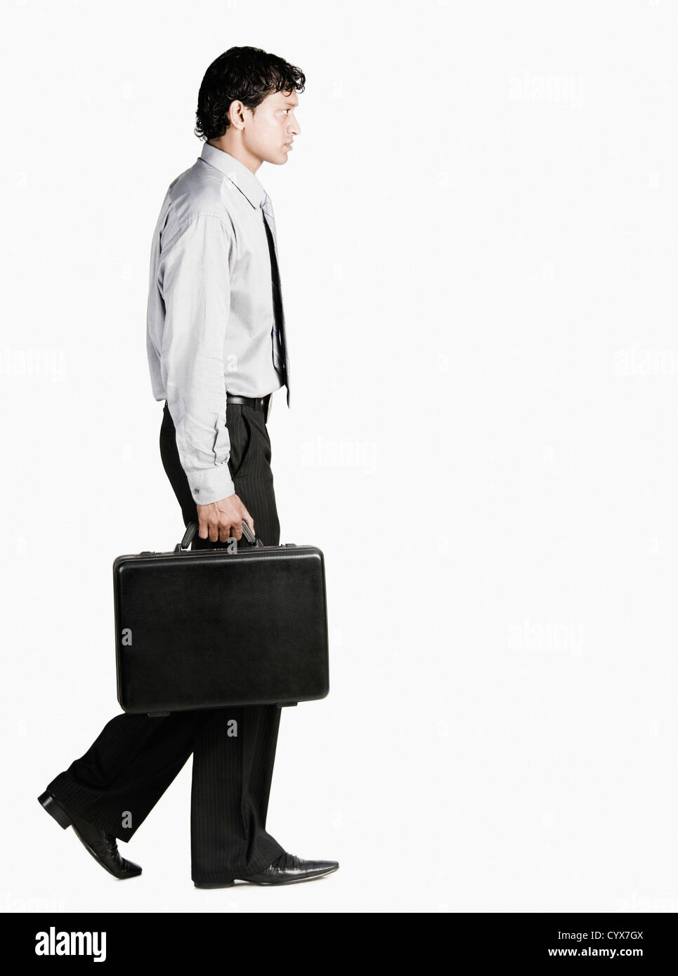 Businessman walking with a briefcase Stock Photo - Alamy