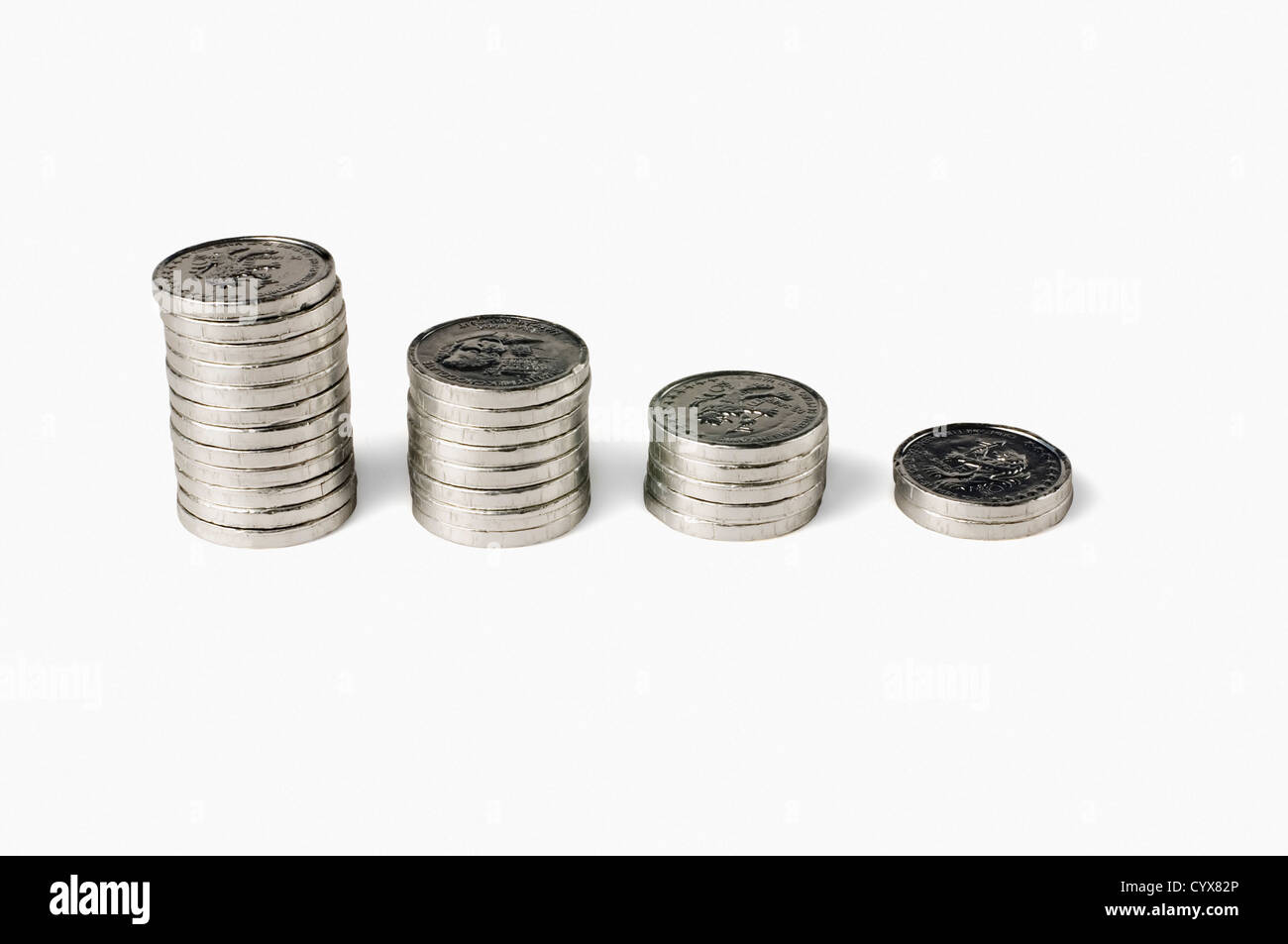 Stacks of coins depicting a bar graph of declining economy Stock Photo