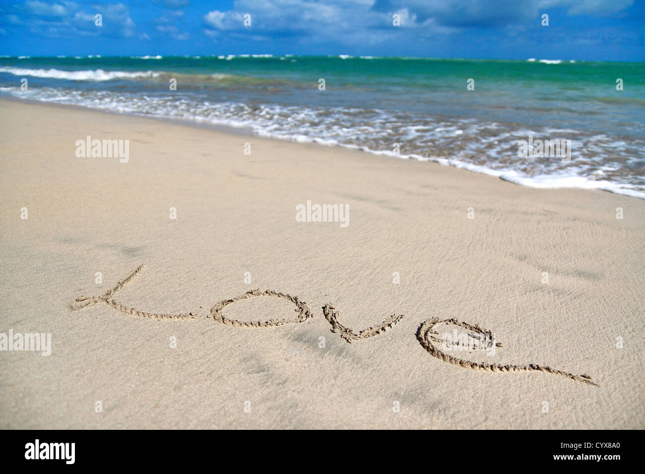 Sign Love on sand on tropical beach Stock Photo