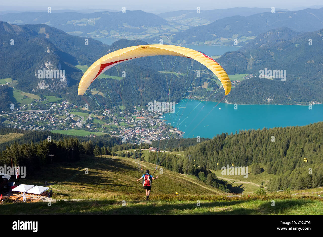 A paraglider is walking down the hill and ready to fly in the austrian alps Stock Photo