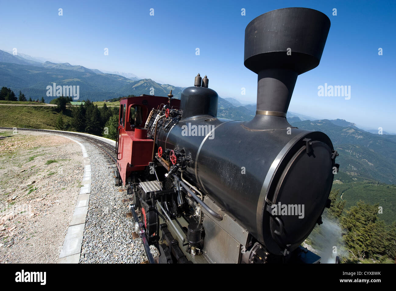 An old steam locomotive is climbing up the 'schafbergbahn' on to the top of the Schafberg (1783 meters) in Austria. Stock Photo