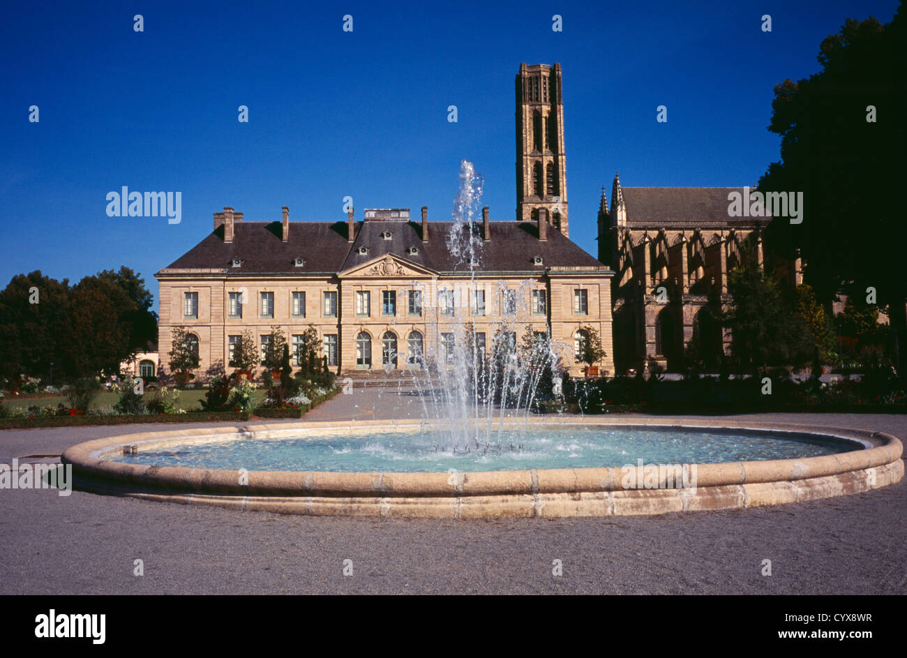 Musee Municipal de L’Eveche with Cathedral gardens on the right and fountain in the foreground European French Garden Plants Stock Photo