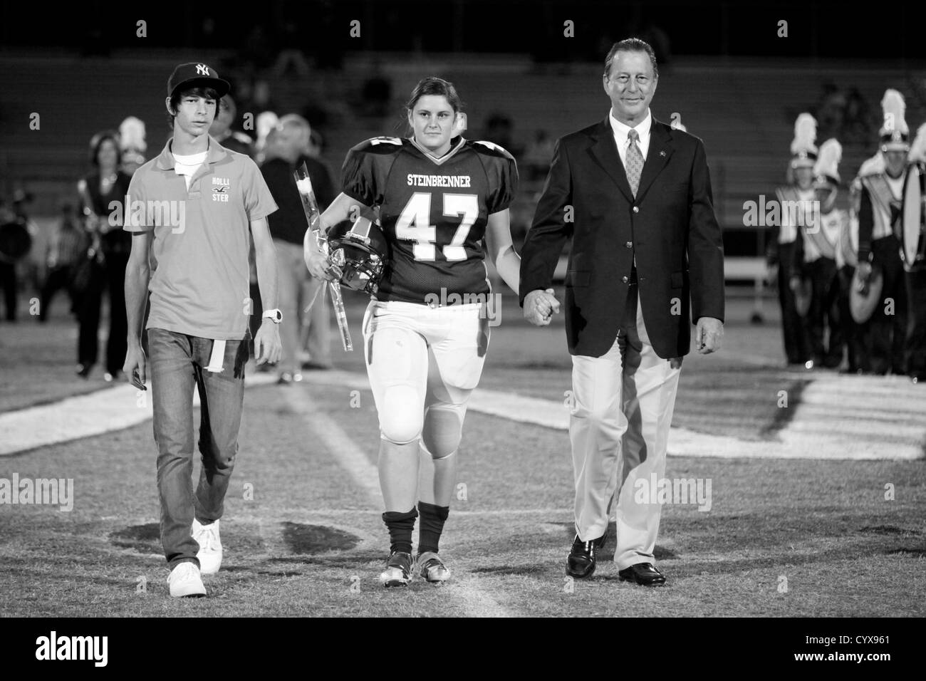 Nov. 02, 2012 - Tampa, Florida, U.S. - Jessica holds her father's hand, Wade Weatherman III as she walks with him and her brother, Wade Weatherman IV down the field at Steinbrenner High School during senior night on Friday evening. 'Since my mom passed away it's been a priority to get closer and have a better relationship with my dad,' said Weathermen. 'He's been extremely supportive of my athletics.' [Eve Edelheit, Times] (Credit Image: © Eve Edelheit/Tampa Bay Times/ZUMAPRESS.com) Stock Photo