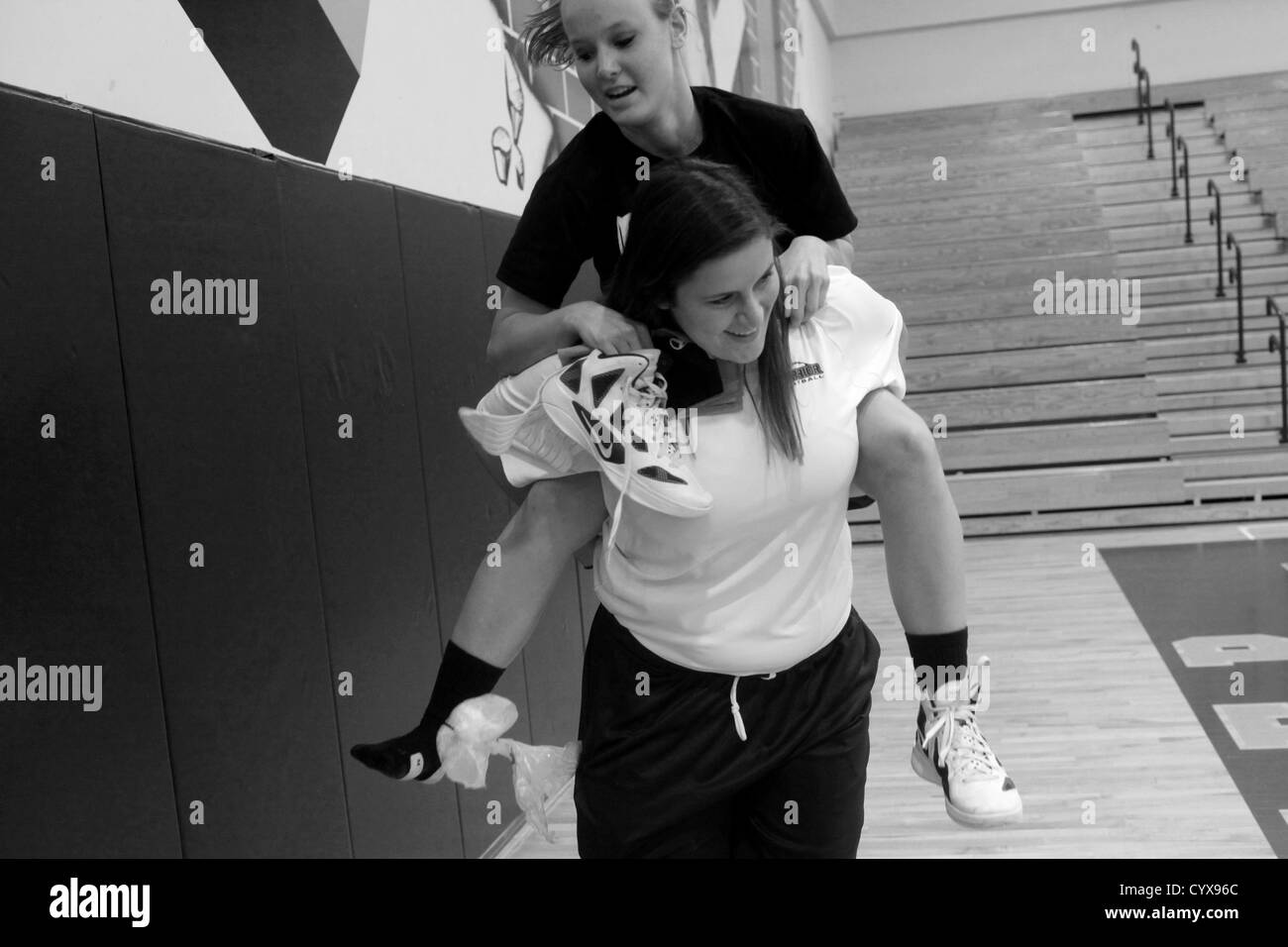 Nov. 02, 2012 - Tampa, Florida, U.S. - Jessica givers her basketball teammate and friend Shannon Perez a piggyback ride during practice after Perez hurt her ankle at Steinbrenner high school on Friday afternoon. Jessica is also very close with her basketball teammates and hopes that the team will make it to state this year. [Eve Edelheit, Times] (Credit Image: © Eve Edelheit/Tampa Bay Times/ZUMAPRESS.com) Stock Photo