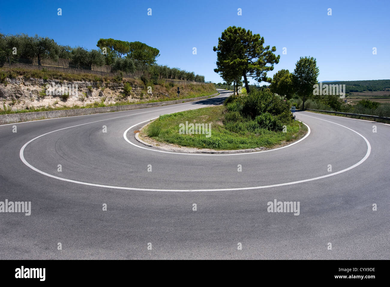 A hairpin bend on a road in the mountains of Toscany in Italy Stock Photo