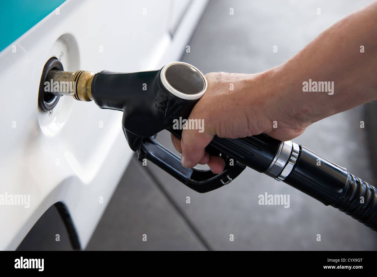 A man filling his tank with diesel Stock Photo
